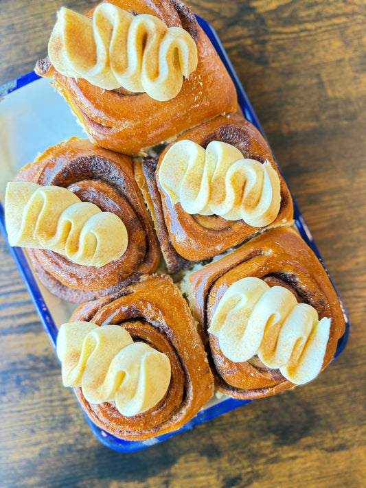 Freshly baked cinnamon bun with glossy glaze at Krumb Bakery Belfast