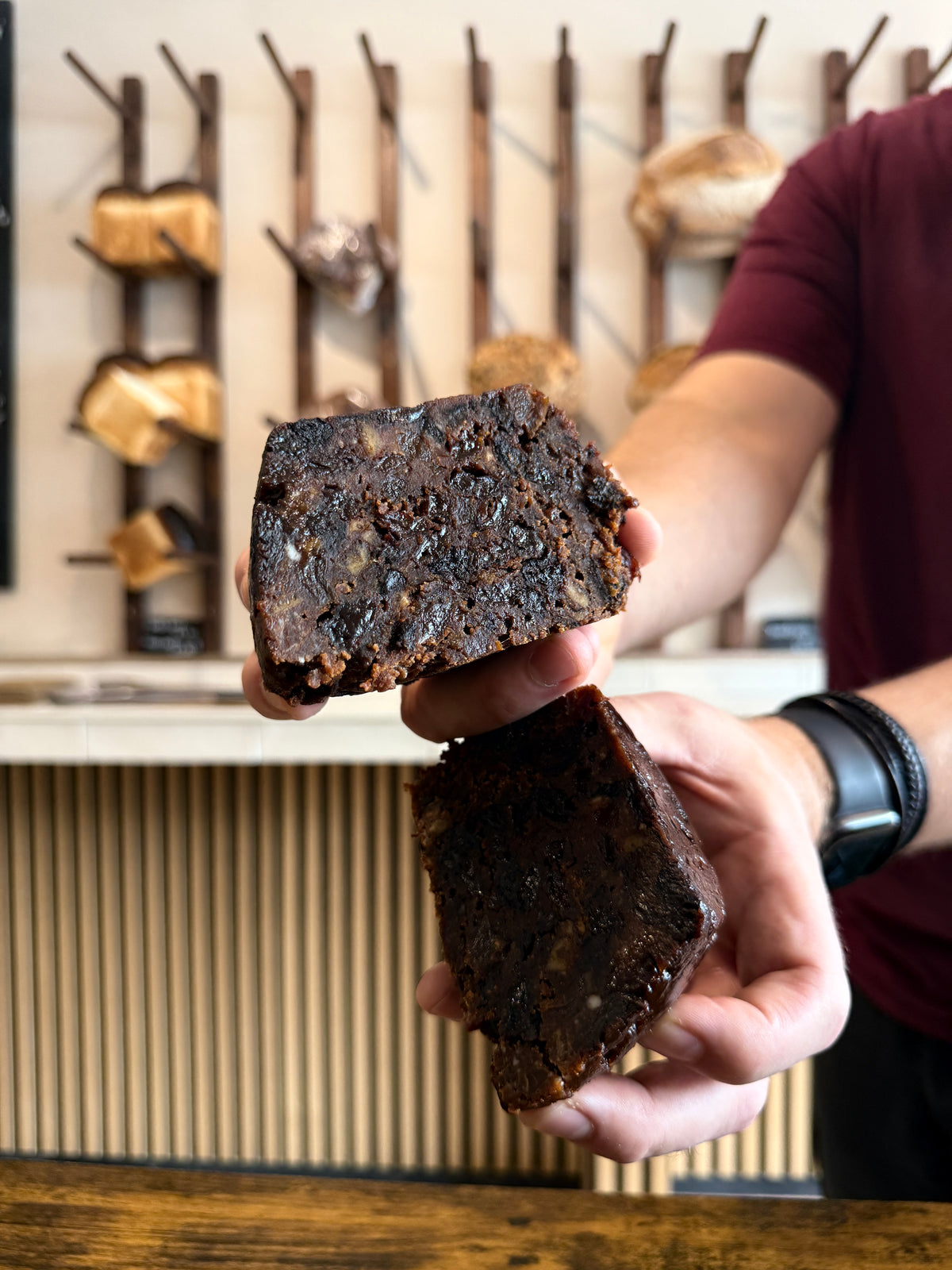 Krumb baker holding two halves of a Christmas pudding