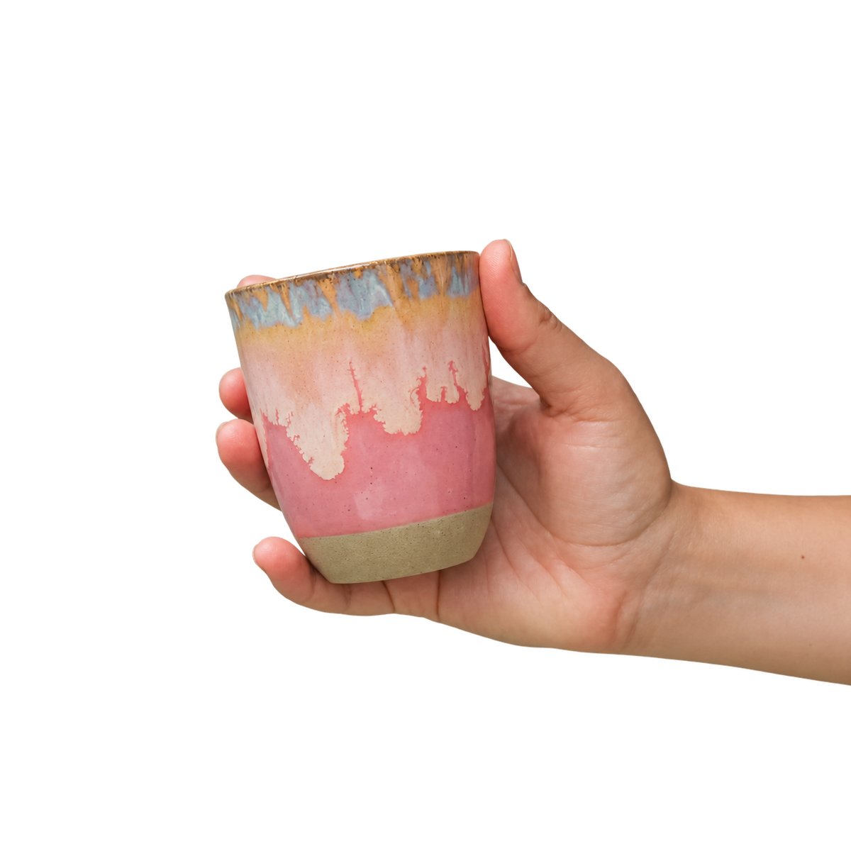 Hand holding Krumb's handmade pink drip cup